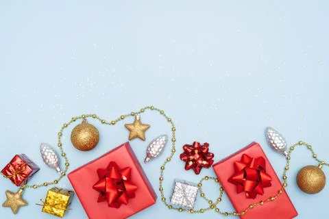 Gifts boxes or presents boxes with red bows, star and ball on blue background Stock Photos