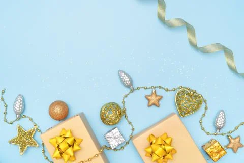 Gifts boxes or presents boxes with golden bows, star and ball on blue backgro Stock Photos