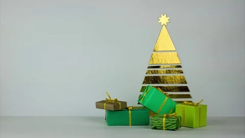 Gifts in green wraps move from different sides to the Christmas tree. Stock Footage 82277013