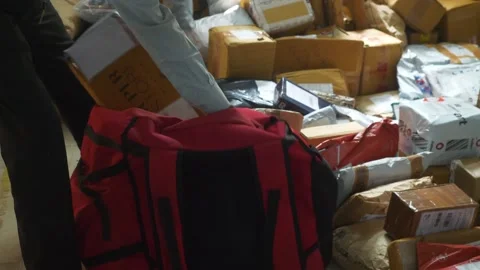 Gig worker packing parcels at logistics and supply chain hub 스톡 동영상 334688173