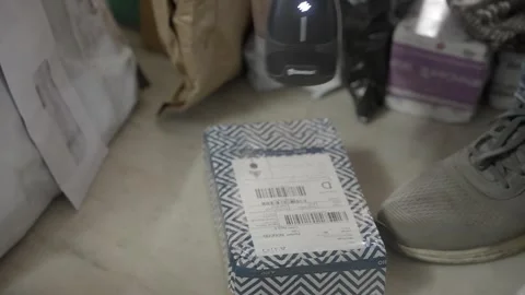 Gig worker scanning QR code of packed parcels at logistic warehouse 스톡 동영상 327692513