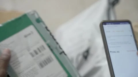 Gig worker scanning QR code of packed parcels using mobile scanner, logistic 스톡 동영상 327692516