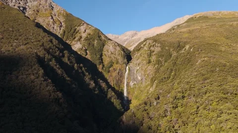 Gigantic Devil’s Punchbowl Waterfall at Arthurs Pass during sunset time in New Stock Footage 309644989