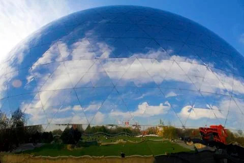 Gigantic metallic spherical structure with a perfect reflection in the street Stock Photos