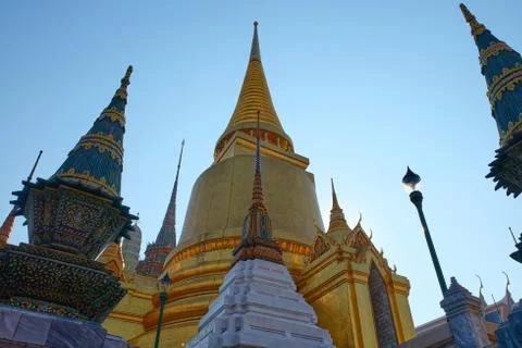 Gilded Buddhist temple of conical shape. Spiers of Asian religious buildings. Stock Photos