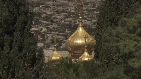 Gilded church steeples through trees in Jerusalem Stock Footage 86759352