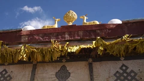 Gilded dharmachakra wheel and twin deer roof ornament on a monastery, Lo Stock-Footage 344530583