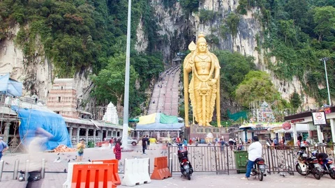 Gilded statue of the god Muruga Time-Lapse  Batu Caves Kuala Lumpur. pan up Stock Footage 123428376