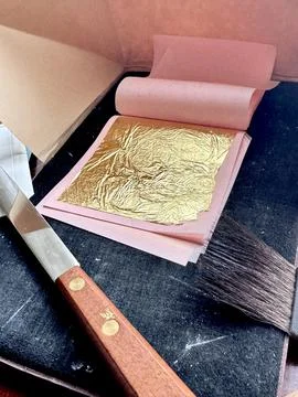 Gilding Tools and Gold Leaf on Artist’s Desk. Stock Photos