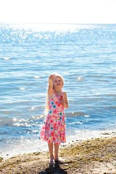 Gilrl with soap bubbles on the seashore Stock Photos