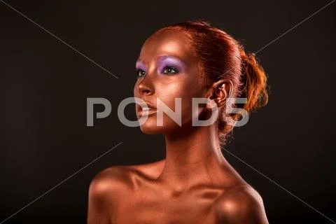 Gilt. Golden Woman's Face Closeup. Futuristic Gilded Make-up. Painted Skin Stock Photos