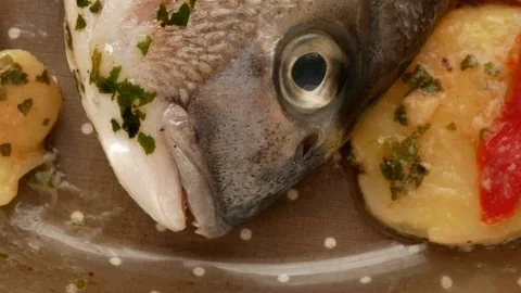 Gilt-head bream fish ready to cook with potatoes Stock Footage