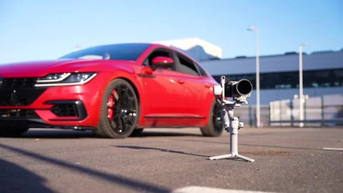 Gimbal Camera Setup Near Red Sports Car Video stock 310287550