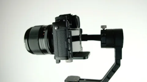 Gimbal with digital camera rotates on white background. Stock Footage 109430781