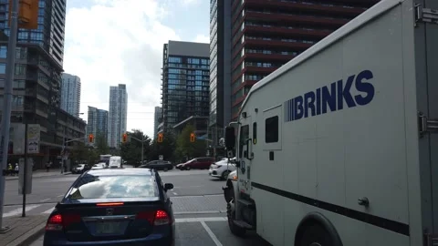 Gimbal Driving Next to Brinks Secure Cash Management Truck in Toronto Video stock 147451972
