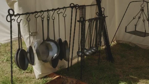 Gimbal pan left to right over handmade iron pans, ladles, and metal products Stock Footage 319947383