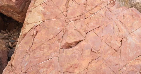 Gimbal pull back movement on brown and pink color flat rock 4k Stock Footage 316337112