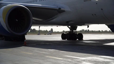 Gimbal shot. Airplane engine of the standing aircraft on the airfield. 4K Video stock 117175382