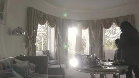 A gimbal shot of a bride getting her hair done with sun flare Stock Footage 150995300