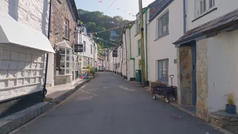 Gimbal walking shot through narrow coastal village street in Polperro Cornwall Stock Footage 336032453