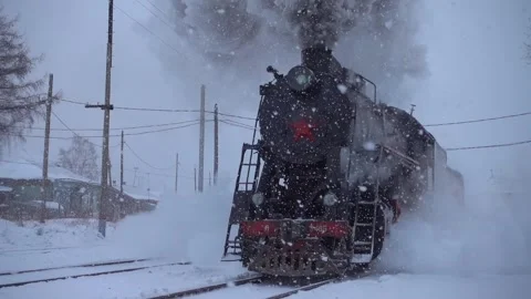 Gimbal winter snow blizzard train steam locomotive rides railway Russia Siberia Stock Footage 155668320