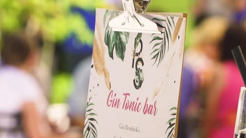 Gin tonic sign with blurred background. Picnic, event. Stock Footage 121175251