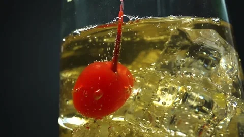 Ginger ale poured over ice with a maraschino cherry Stock Footage 221958302