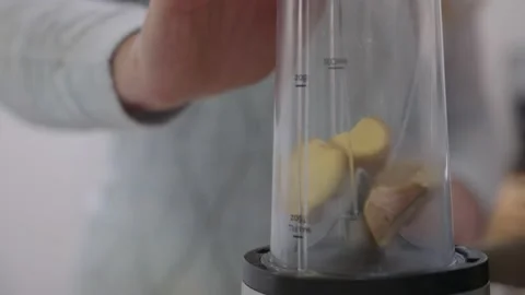 Ginger being Blended by Food Processor Blender to serve as a recipe ingredient Stock Footage 136185791