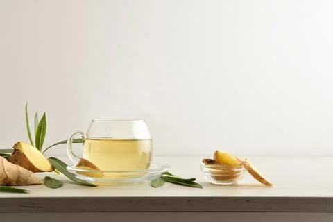 Ginger beverage on table with ginger root white isolated background Stock Photos