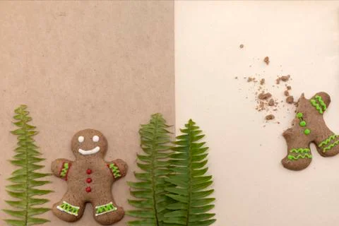 Ginger bread cookies on craft background. Blank notepad with leaf of fern Stock Photos
