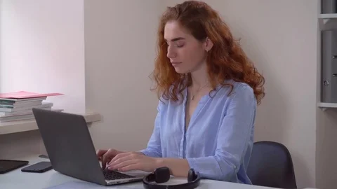 Ginger businesswoman works using pc Stock Footage