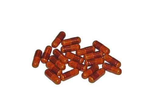 Ginger capsules isolated on white Photos