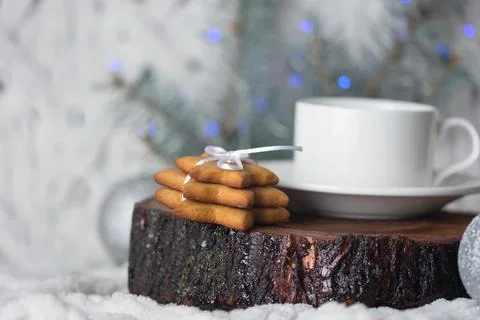 Ginger cookies on an ancient texture stand, a cup and spruce branches with .. Stock Photos