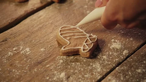 Ginger cookies in the shape of a winter glove are decorated with cream, giving Stock Footage 294834293