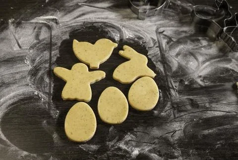 Ginger dough in the form of eggs, rabbit, angel, on the table. Blank for cookies Stock Photos