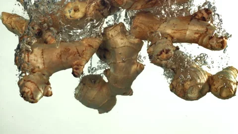Ginger falling underwater on a white background. Filmed on a high-speed camera Stock Footage 322827158