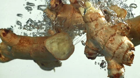 Ginger falling underwater on a white background. Filmed on a high-speed camera Stock Footage 322886367