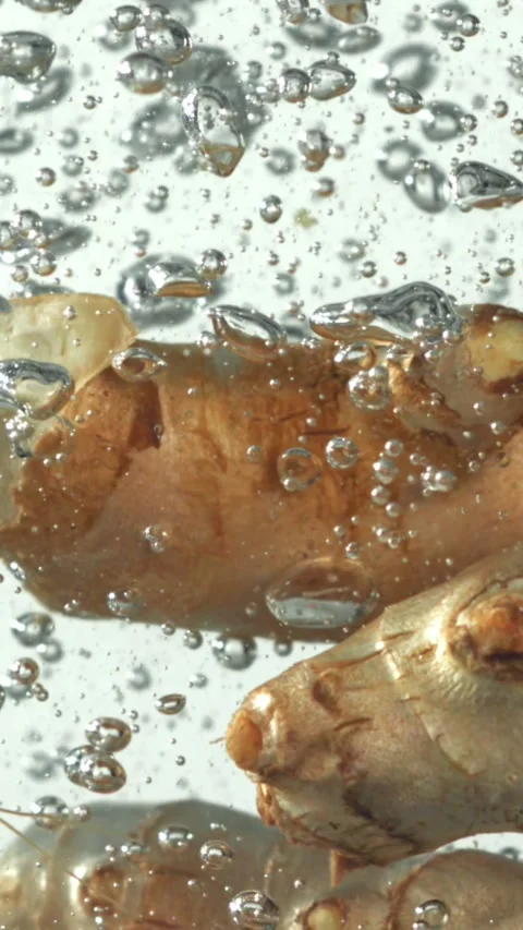 Ginger falling underwater on a white background. Filmed on a high-speed camera Stock Footage 335382441