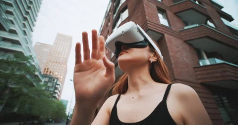 Ginger girl using virtual reality in a urban centre Stock Footage 201687104