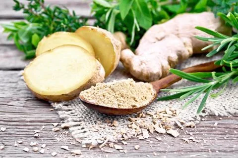 Ginger ground in spoon with root on board Stock Photos