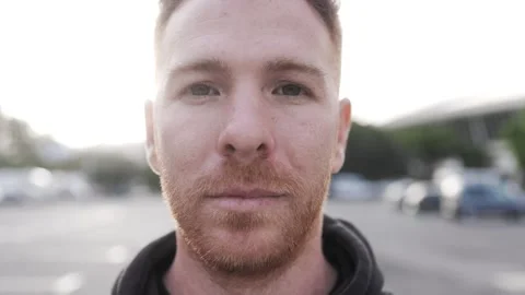 Ginger hair man looking at camera with city street on background. Diverse people Stock Footage 277857707