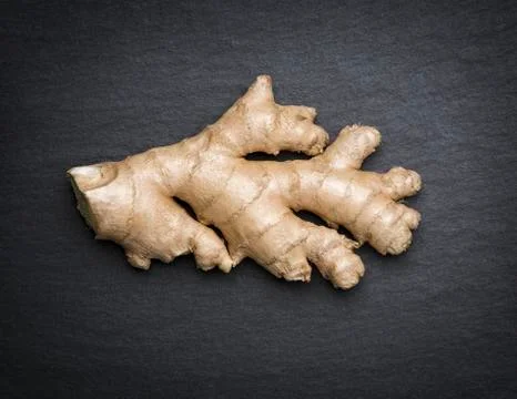 Ginger isolated on dark flagstone. Foto stock