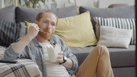 Ginger Man Eating while Watching TV Video stock 125304718