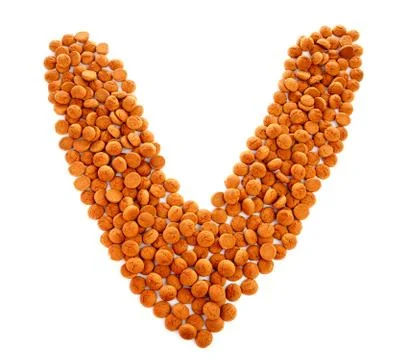 Ginger nuts, pepernoten, in the shape of letter v Stock Photos