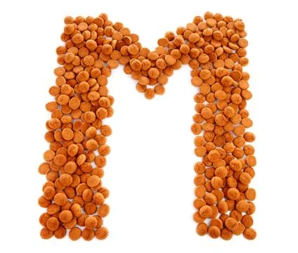 Ginger nuts, pepernoten, in the shape of letter m Stock Photos
