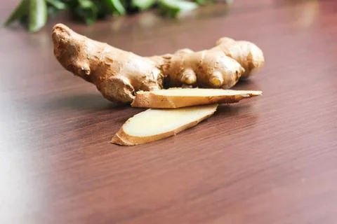 Ginger piece and Ginger cut on top of the table Stock Photos