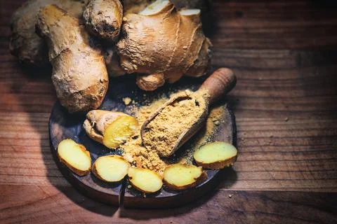Ginger powder with cut root Stock Photos