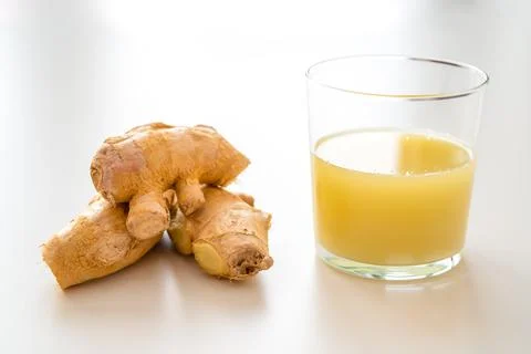 Ginger root and ginger juice. Stock Photos