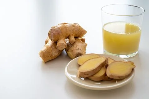 Ginger root and ginger juice. Stock Photos