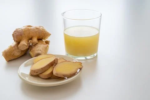 Ginger root and ginger juice. Stock Photos